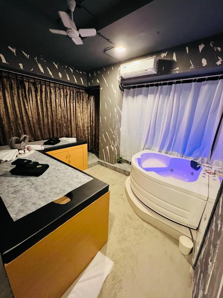MIZMAR treatment room with massage beds and a whirlpool bath