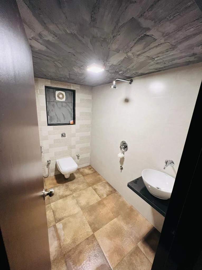MIZMAR guest washroom with warm stone flooring